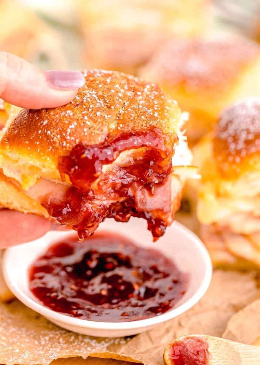 a monte cristo slider is being dipped into jam