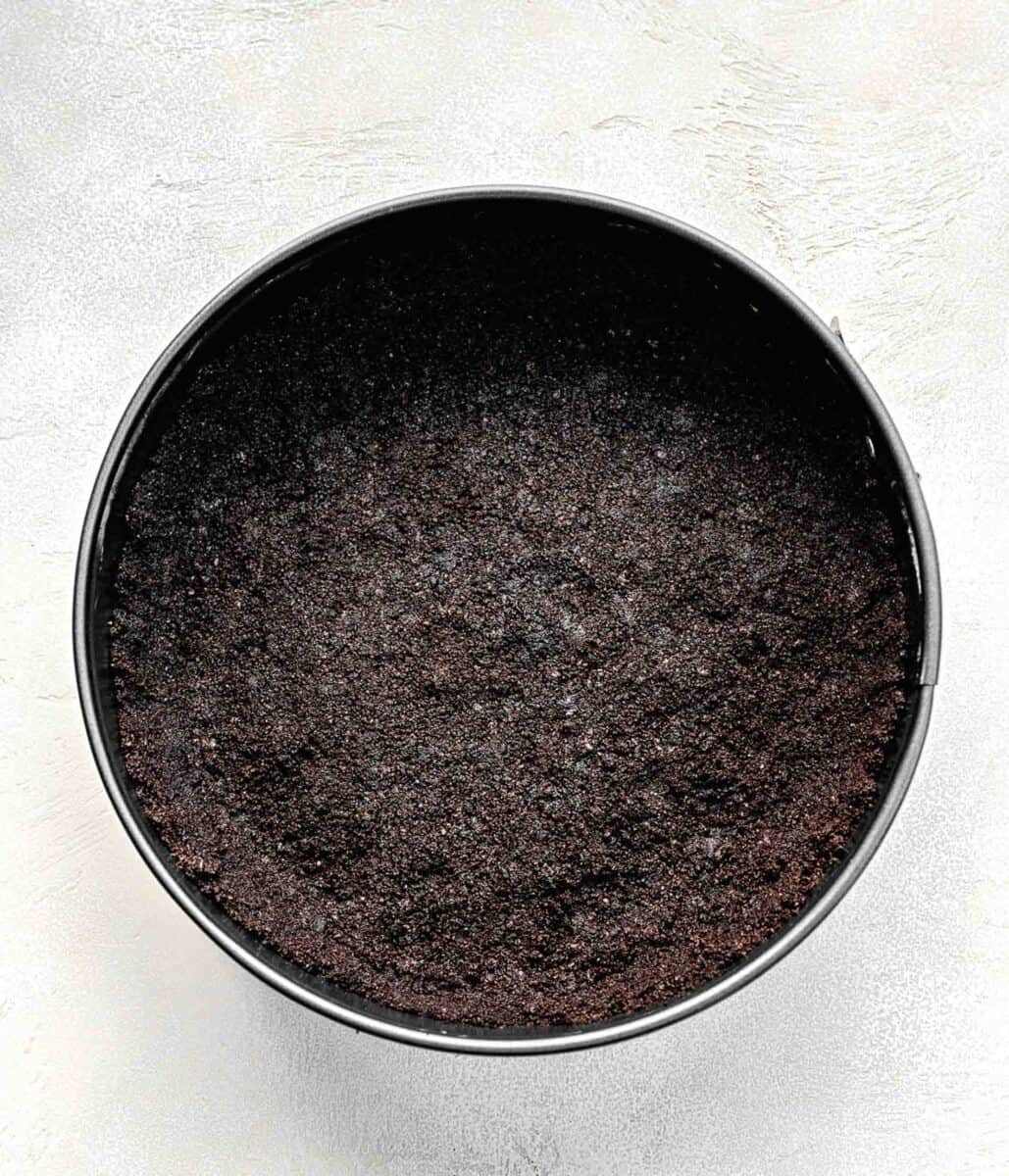 Oreo crust in a springform pan.