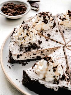 Oreo pie cut into slices on a serving plate.