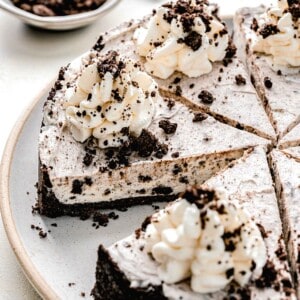 Oreo pie cut into slices on a serving plate.