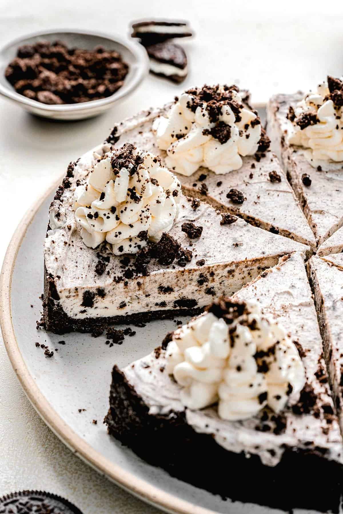 Oreo pie cut into slices on a serving plate.