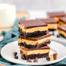 three brownies are stacked on a white plate
