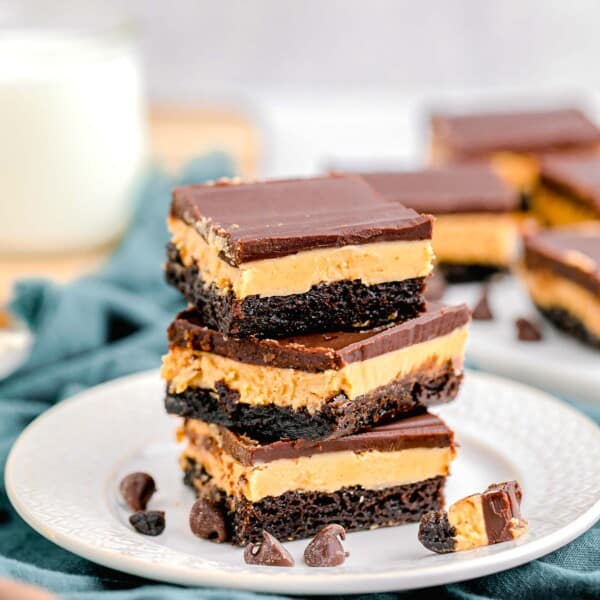 three brownies are stacked on a white plate