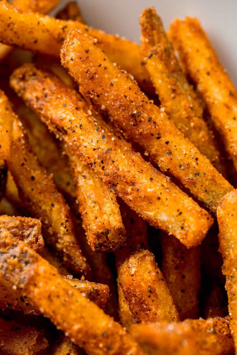 up close image of cajun fries and the seasonings on them