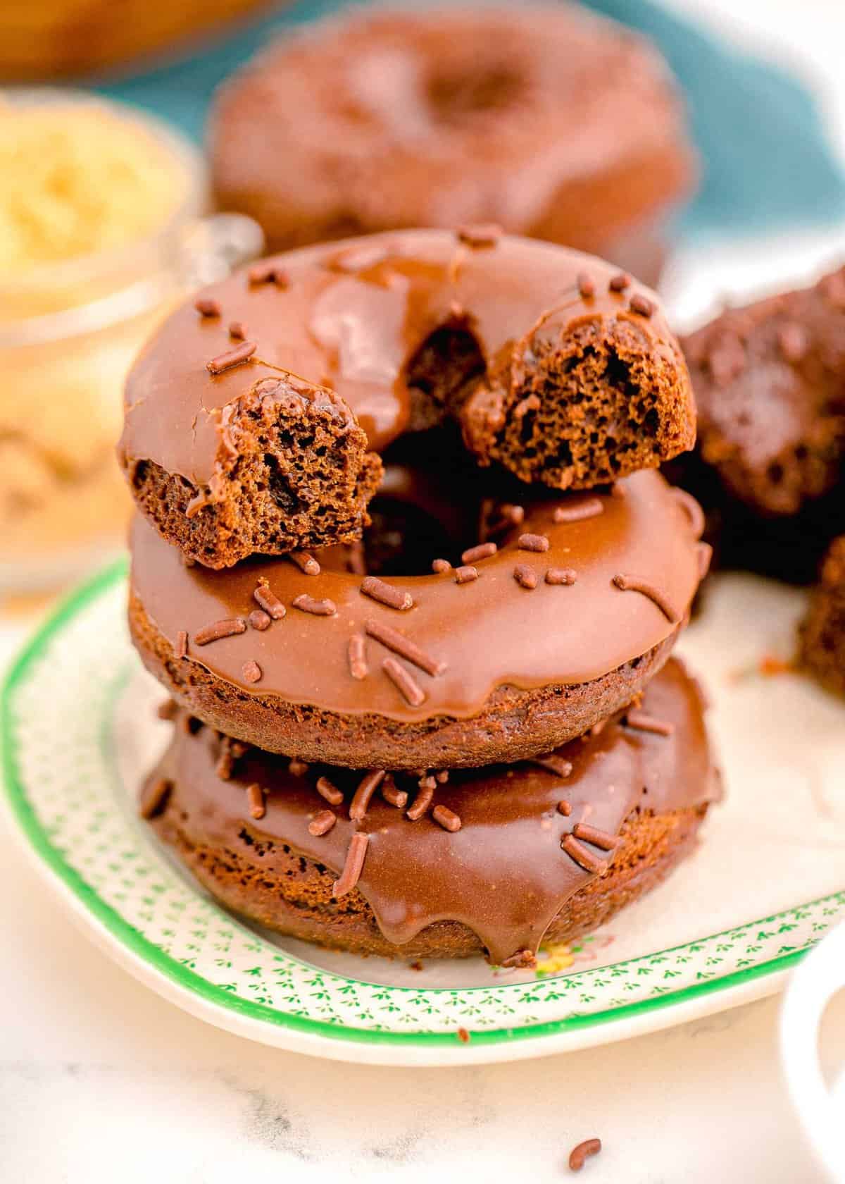 a halved donut is stacked on top of two other donuts