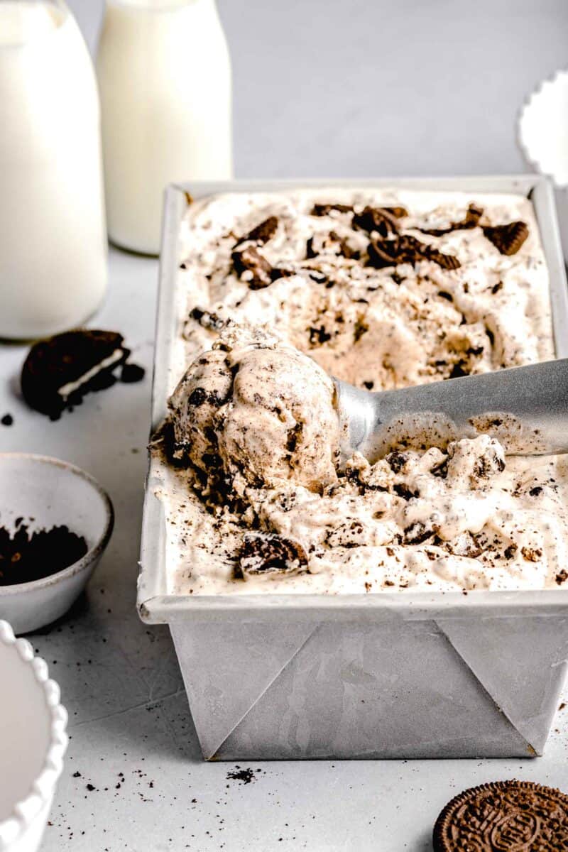 ice cream scoop with a scoop of ice cream in the cookies and cream ice cream tin