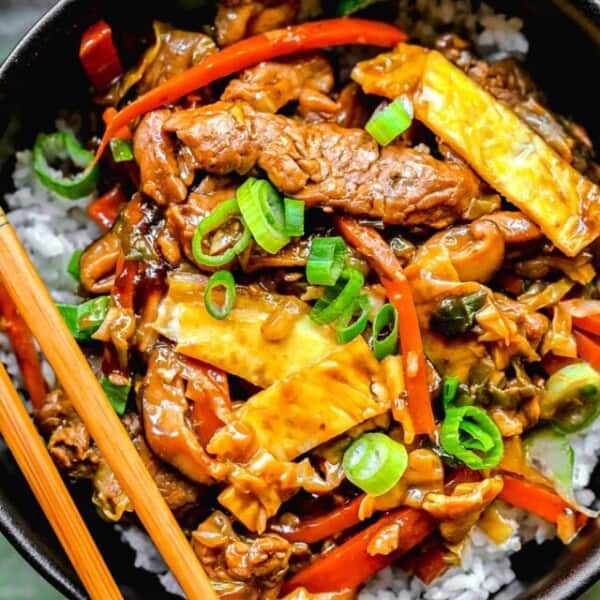 Overhead of moo shu pork in a bowl with chopsticks.