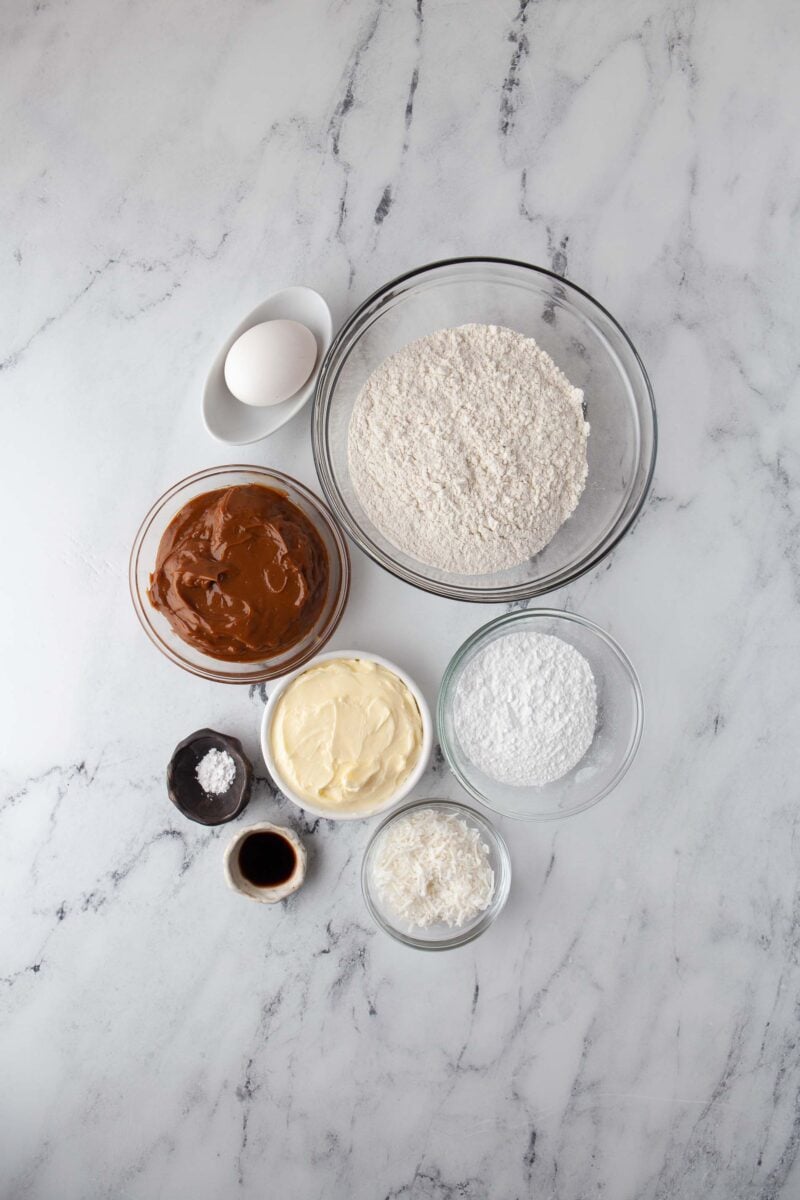 the ingredients for dulce de leche cookies are placed on a marble surface