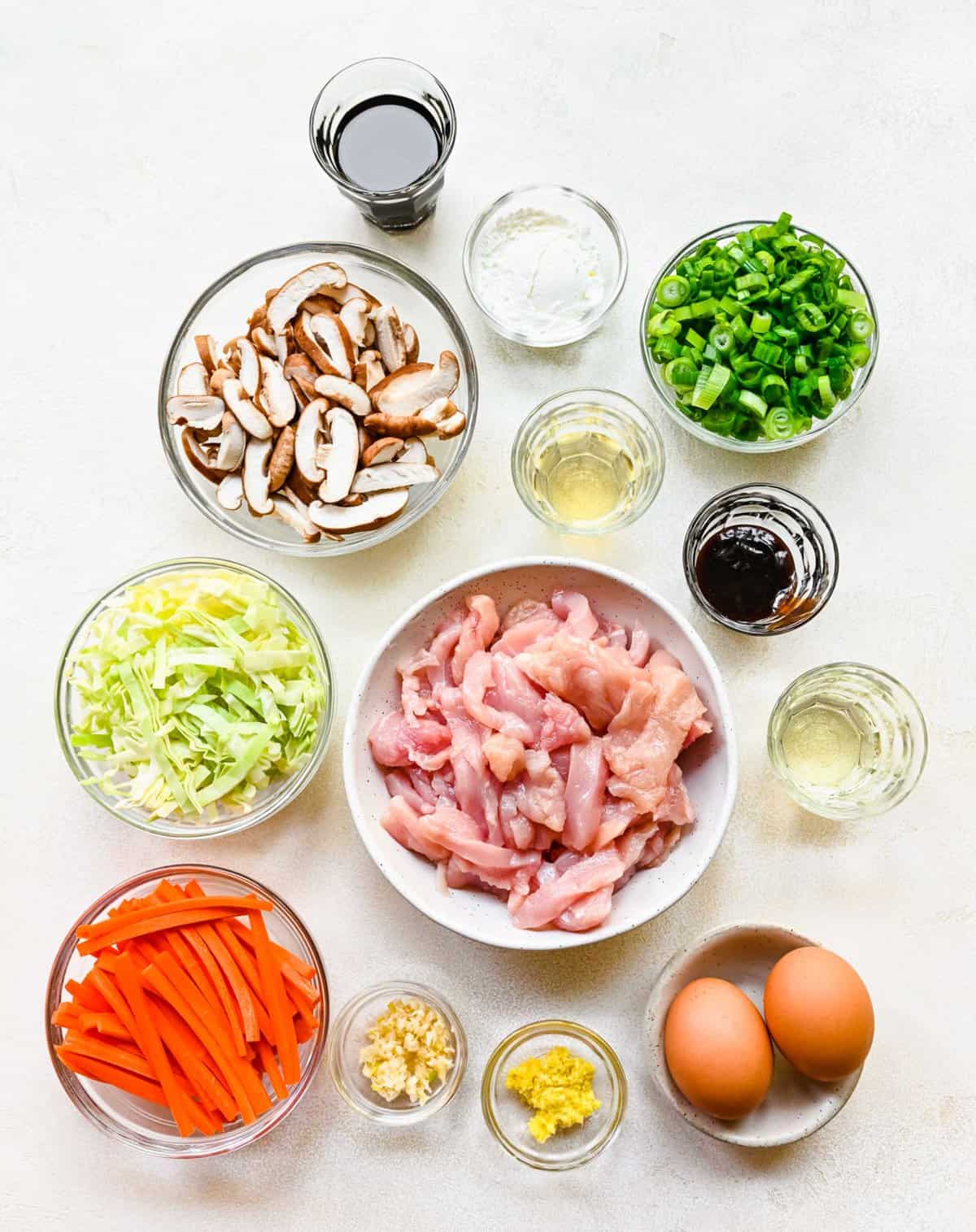 Ingredients for mu shoo chicken separated into bowls.