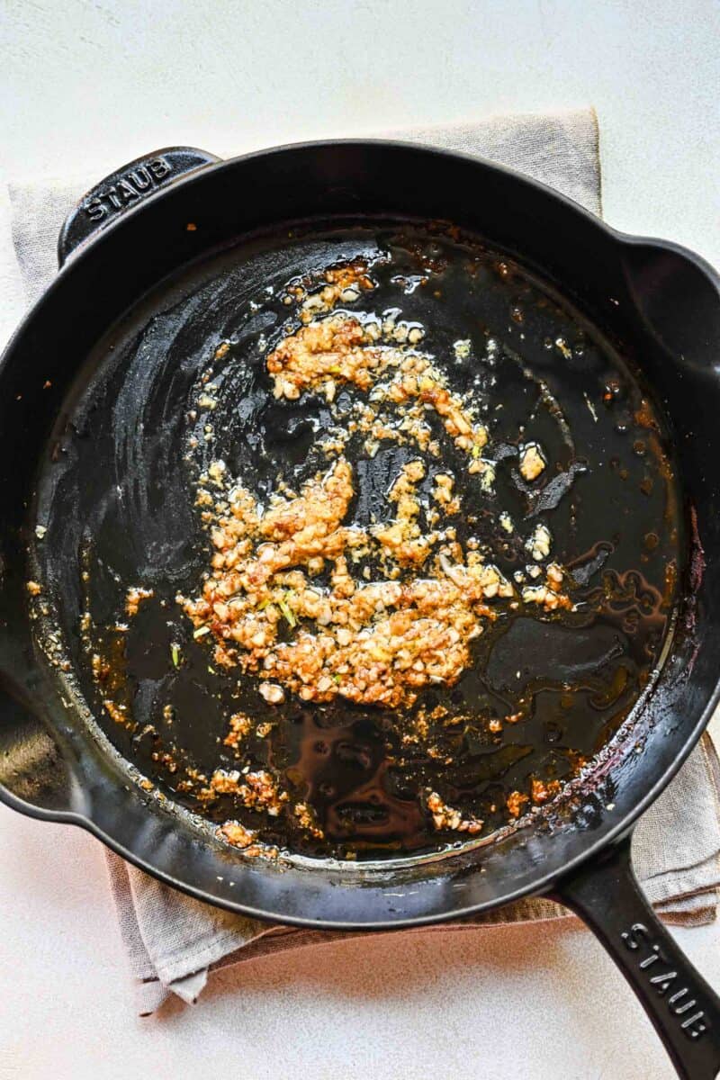 Sautéing garlic and ginger in a pan.