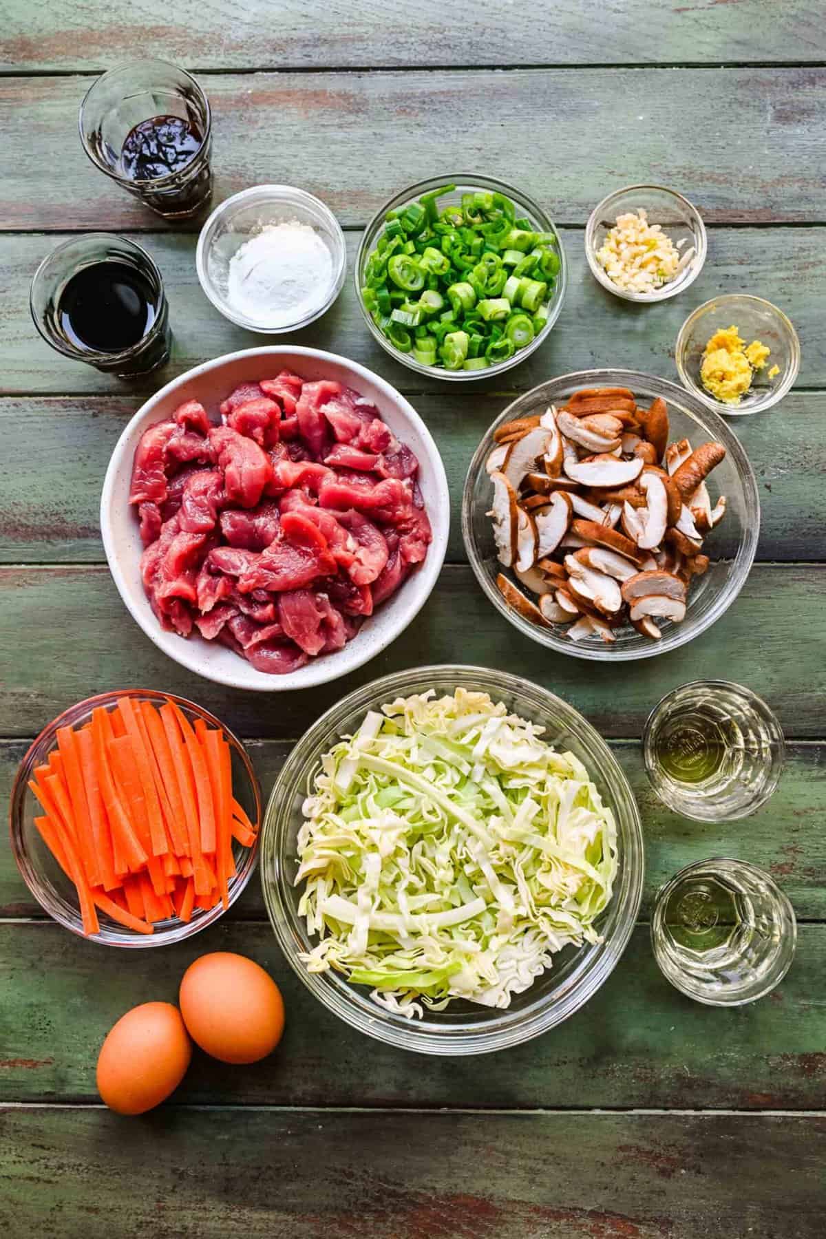 Ingredients for mu shu pork separated into bowls.