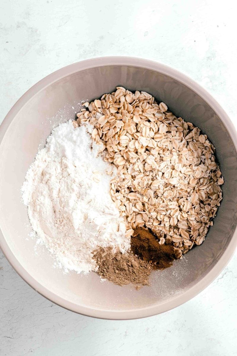 Dry ingredients added to a white bowl.