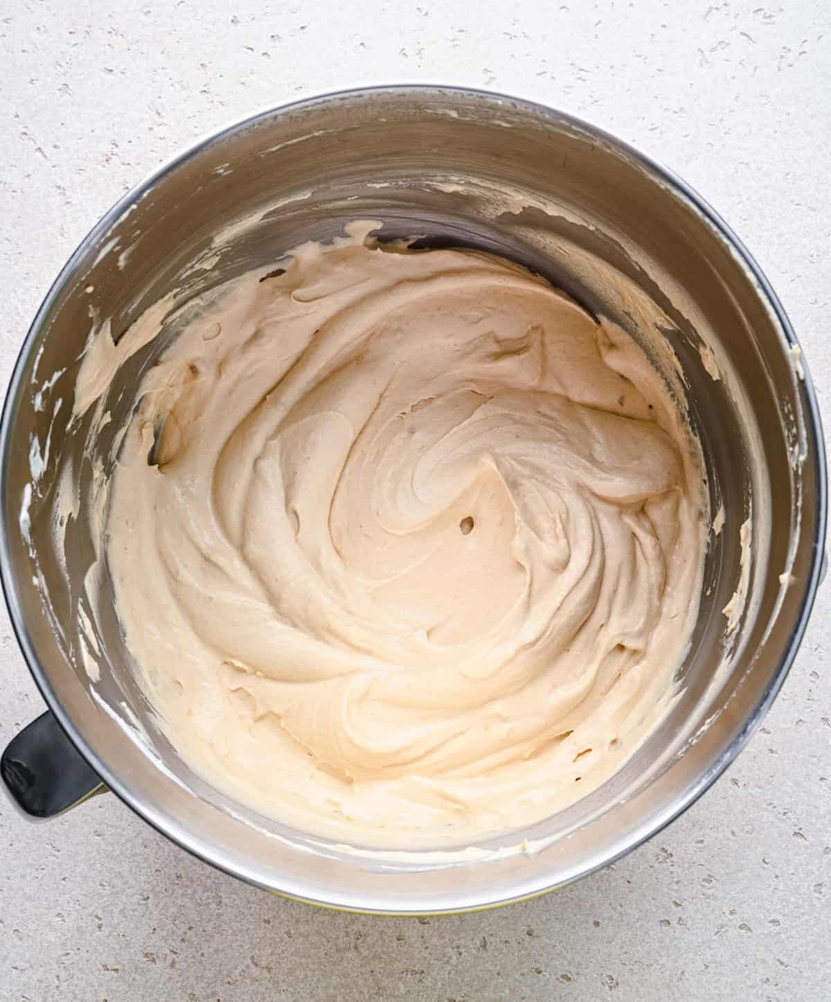 Folding whipped cream into no churn ice cream base.