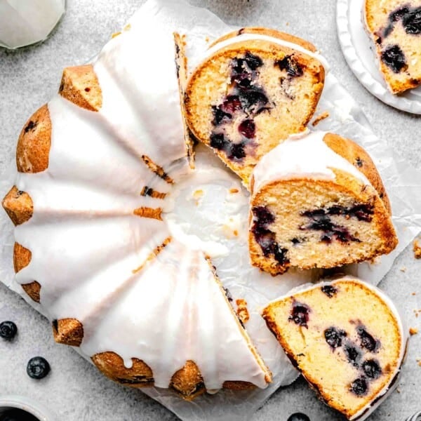 several slices of cake are placed by half of a cake