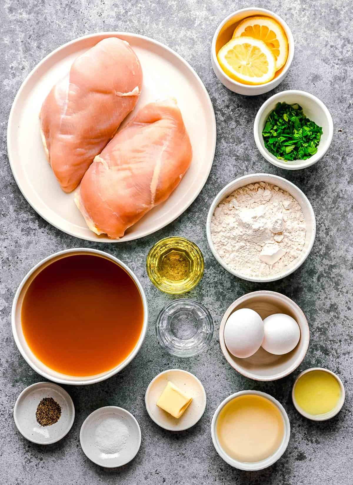 Ingredients for chicken francese arranged on a work surface.