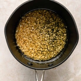 garlic is cooking in olive oil in a large pot