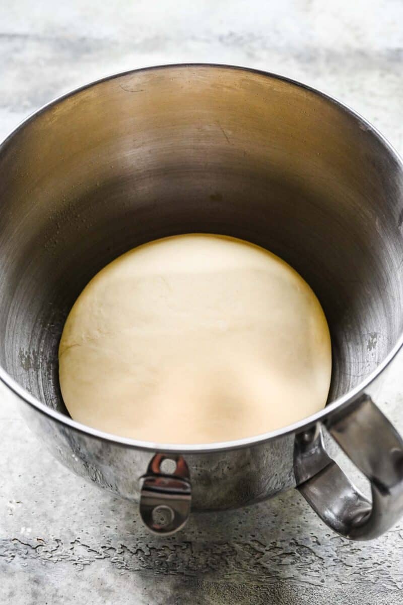 round and smooth dough ball that has doubled in size in a metal stand mixer bowl
