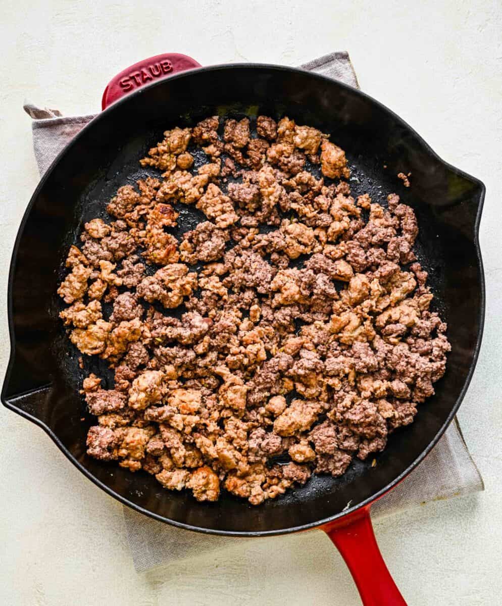 Browning ground beef and Italian sausage in a skillet.