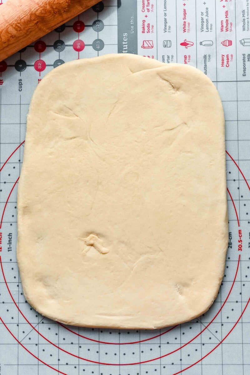 a rectangle sheet of dough is placed on a cutting board