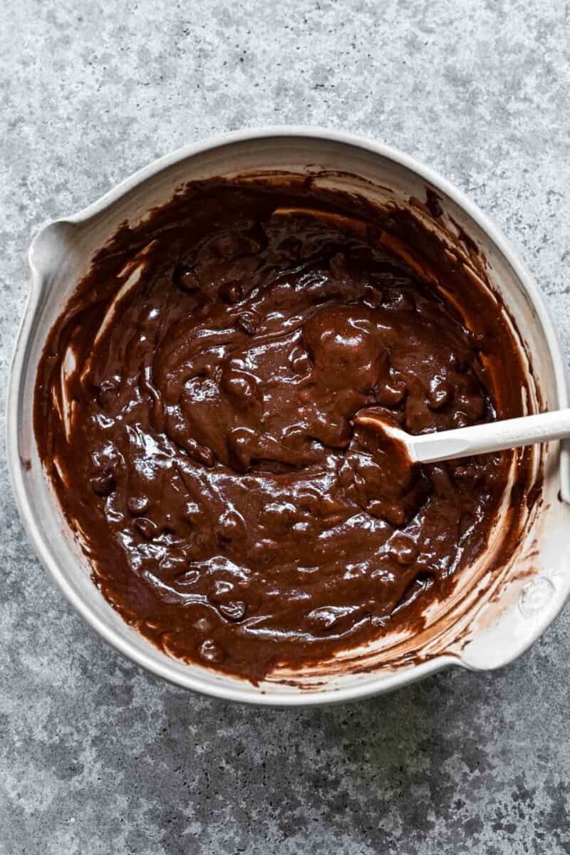 Chocolate chip brownie batter in a mixing bowl.