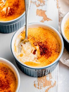 Digging a spoon into creme brulee.
