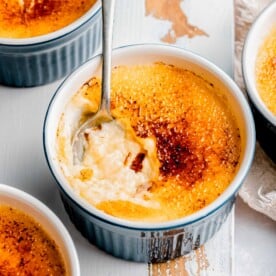Digging a spoon into creme brulee.