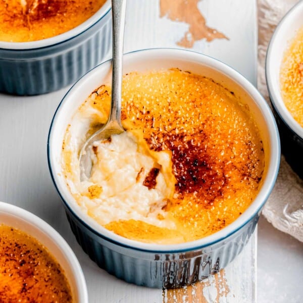Digging a spoon into creme brulee.