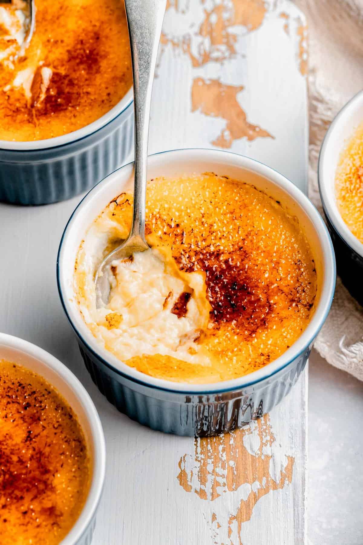 Digging a spoon into creme brulee.