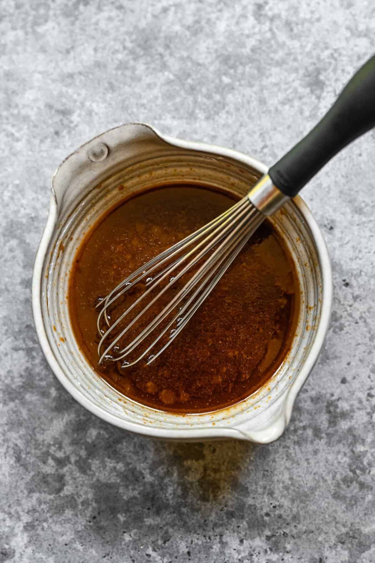 Whisking together ingredients for chow mein sauce.