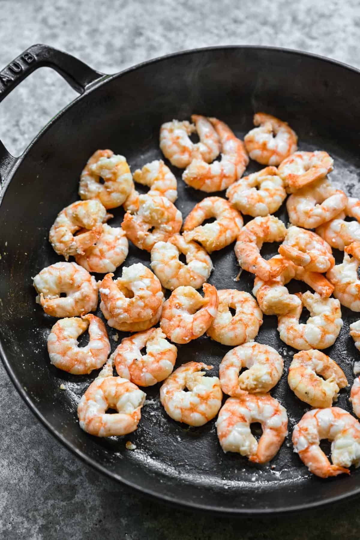 Sautéing shrimp in a skillet.