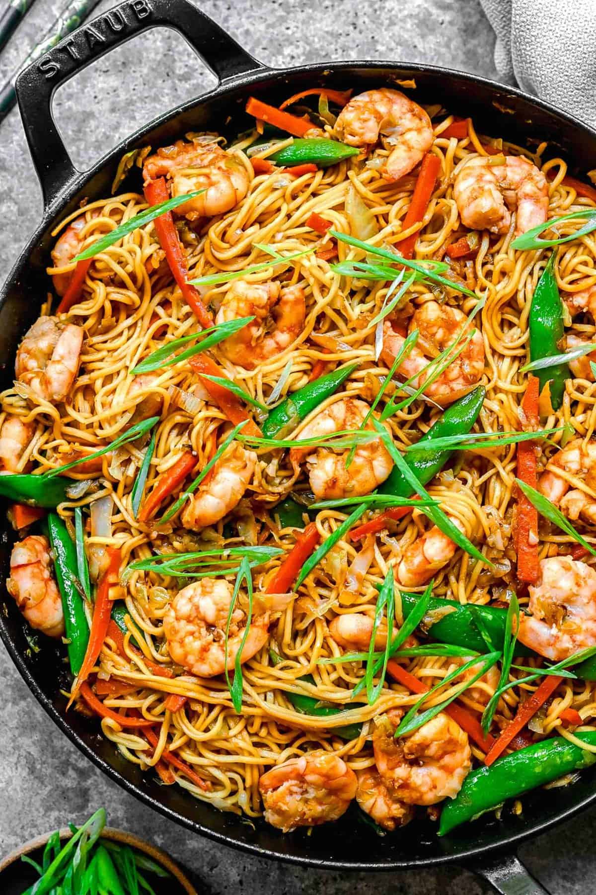 Overhead shot of shrimp chow mein in a skillet.