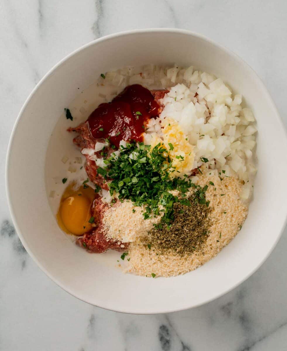 ingredients for air fryer meatloaf in a white bowl