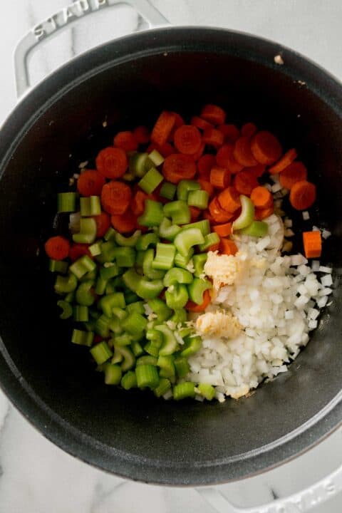 carrots, celery, onion, and garlic added to a large dutch oven