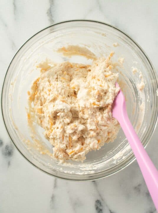 biscuit mixture mixed together with a spatula in a glass bowl