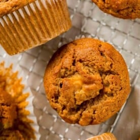 Overhead view of pumpkin banana muffins on a wire rack.