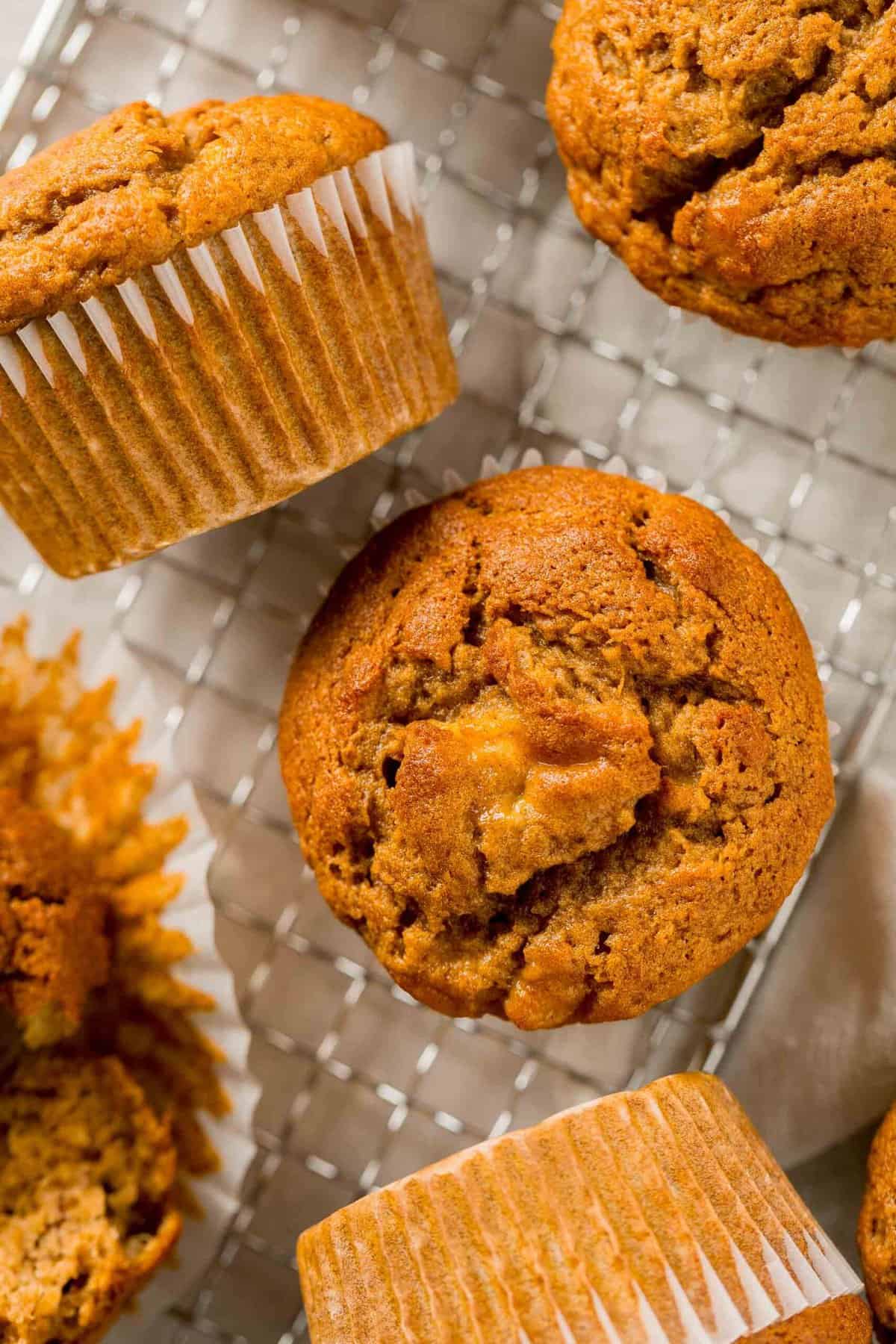 Overhead view of pumpkin banana muffins on a wire rack.