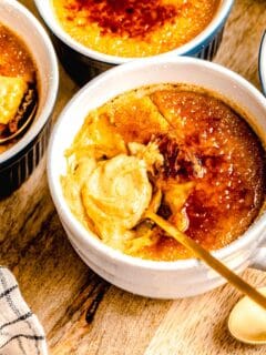 A spoon taking a bite out of pumpkin creme brulee.
