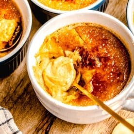A spoon taking a bite out of pumpkin creme brulee.