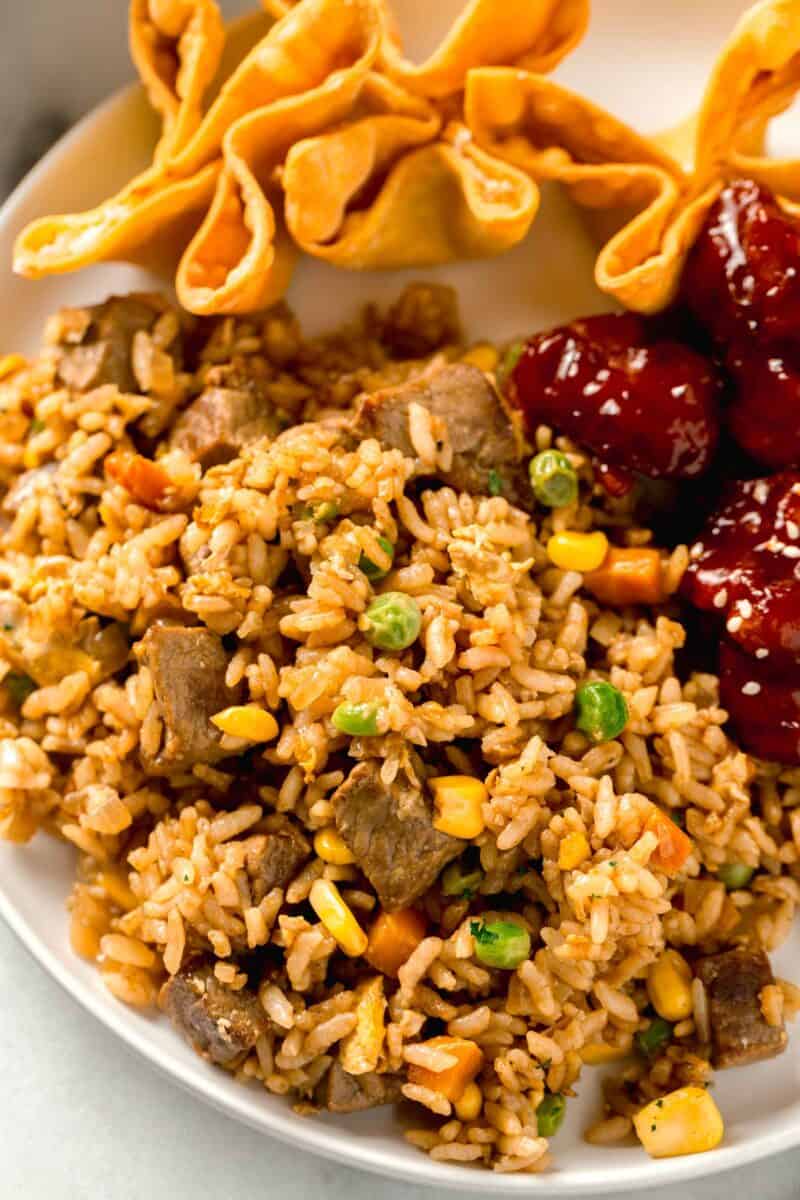 steak fried rice on a plate with other chinese takeout