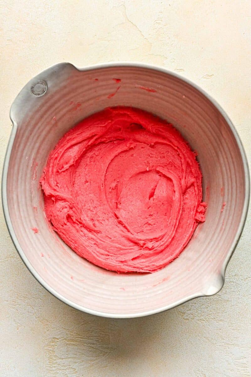 pink tinted cookie dough in a white mixing bowl