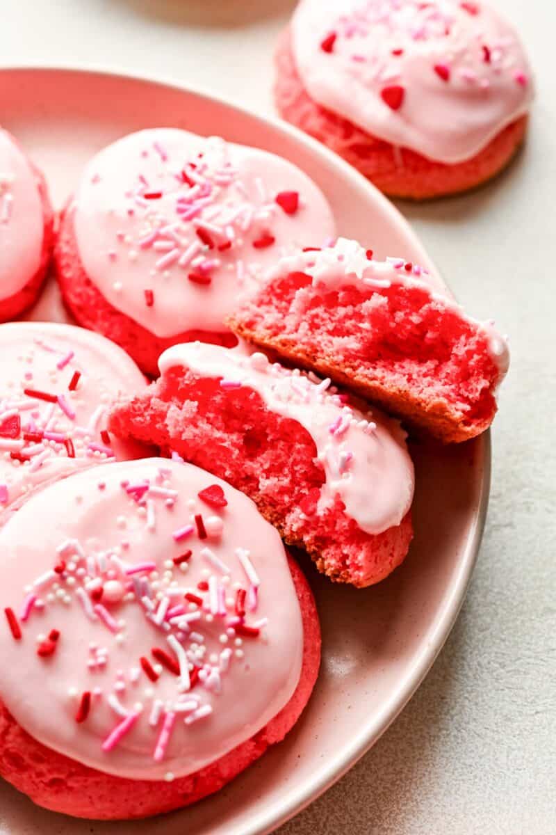 halves of strawberry cream cheese cookies on a plate to show interior