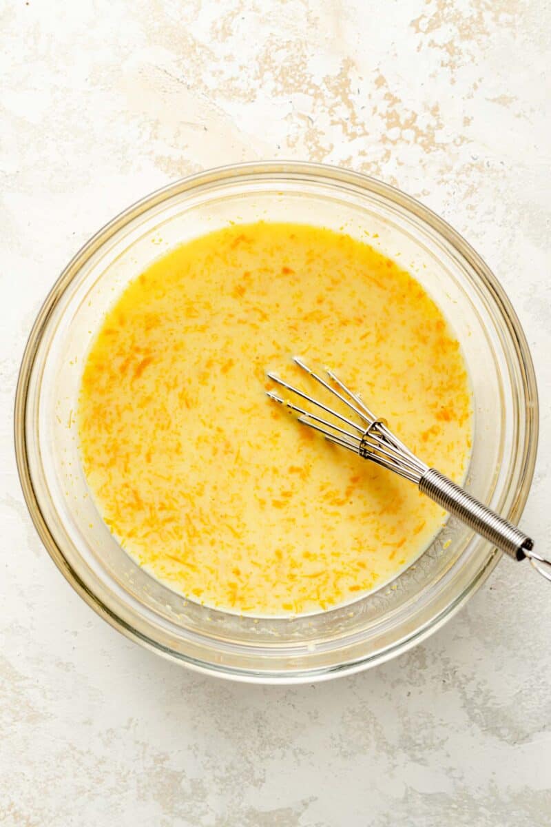 Whisking together wet ingredients for orange pound cake.