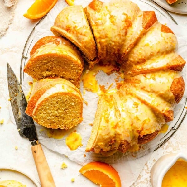 Overhead image of orange pound cake with slices taken out of it.