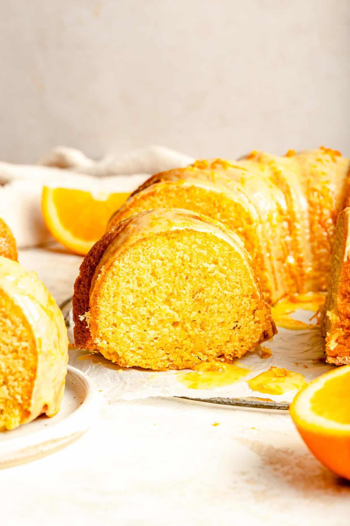 Orange pound cake with a slice taken out of it.