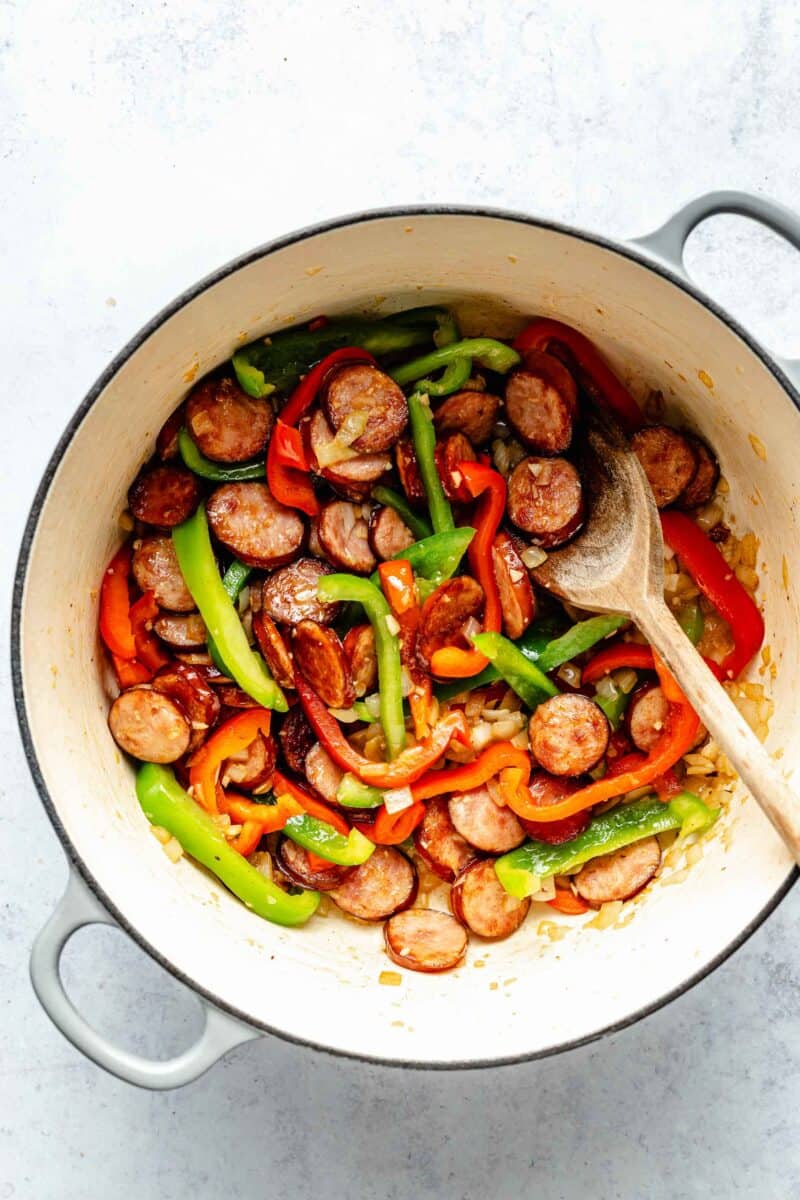 Sautéing bell pepper with smoked sausage.