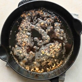 minced garlic cooked in butter in a cast iron skillet