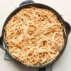 spaghetti pasta tossed in cajun alfredo sauce in a cast iron skillet