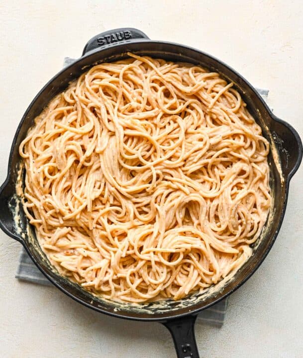 spaghetti pasta tossed in cajun alfredo sauce in a cast iron skillet