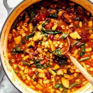 Overhead image of minestrone soup in a pot.