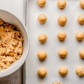 Forming peanut butter dough into balls.